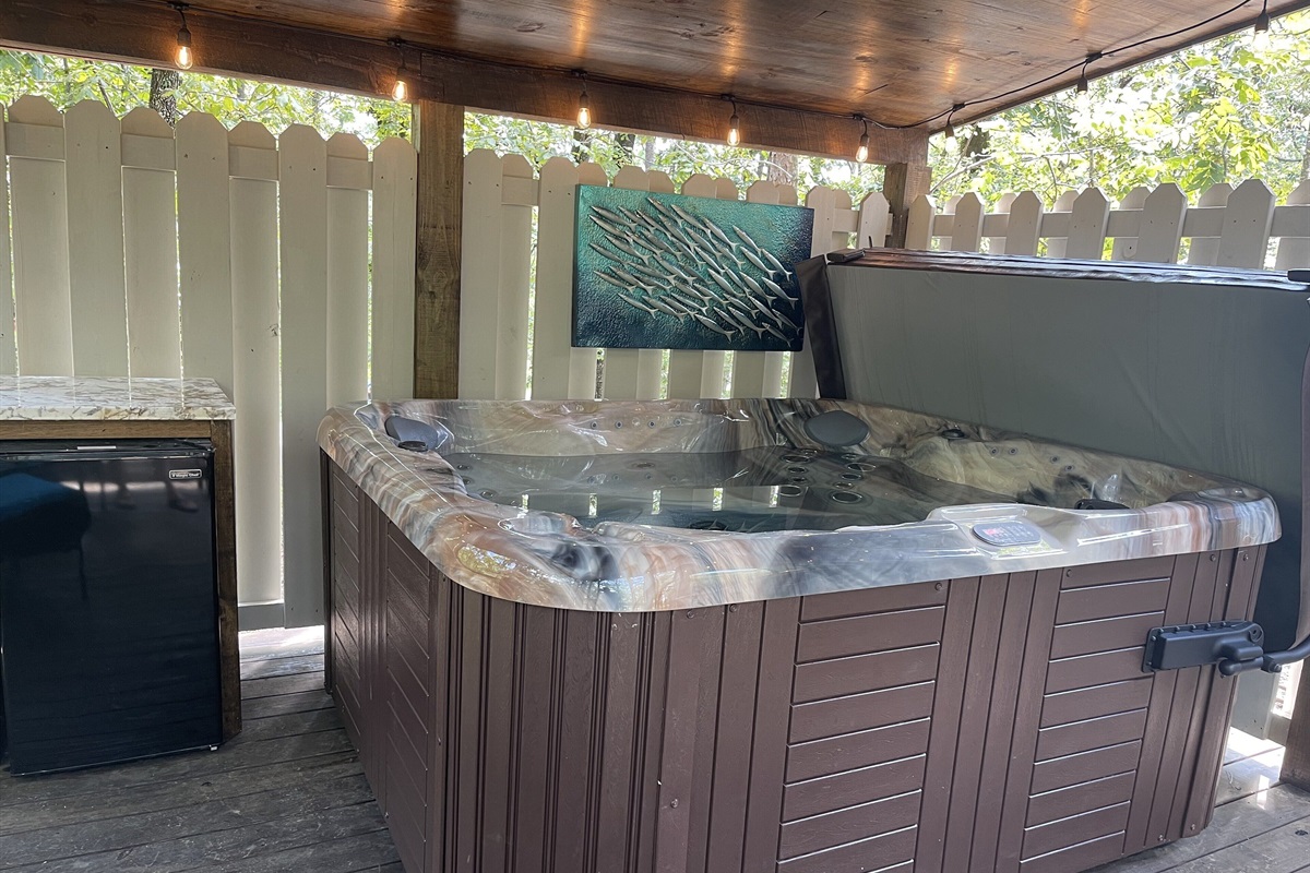 Enjoy a cool beverage in the hot tub by taking advantage of the outdoor refrigerator in arms reach.