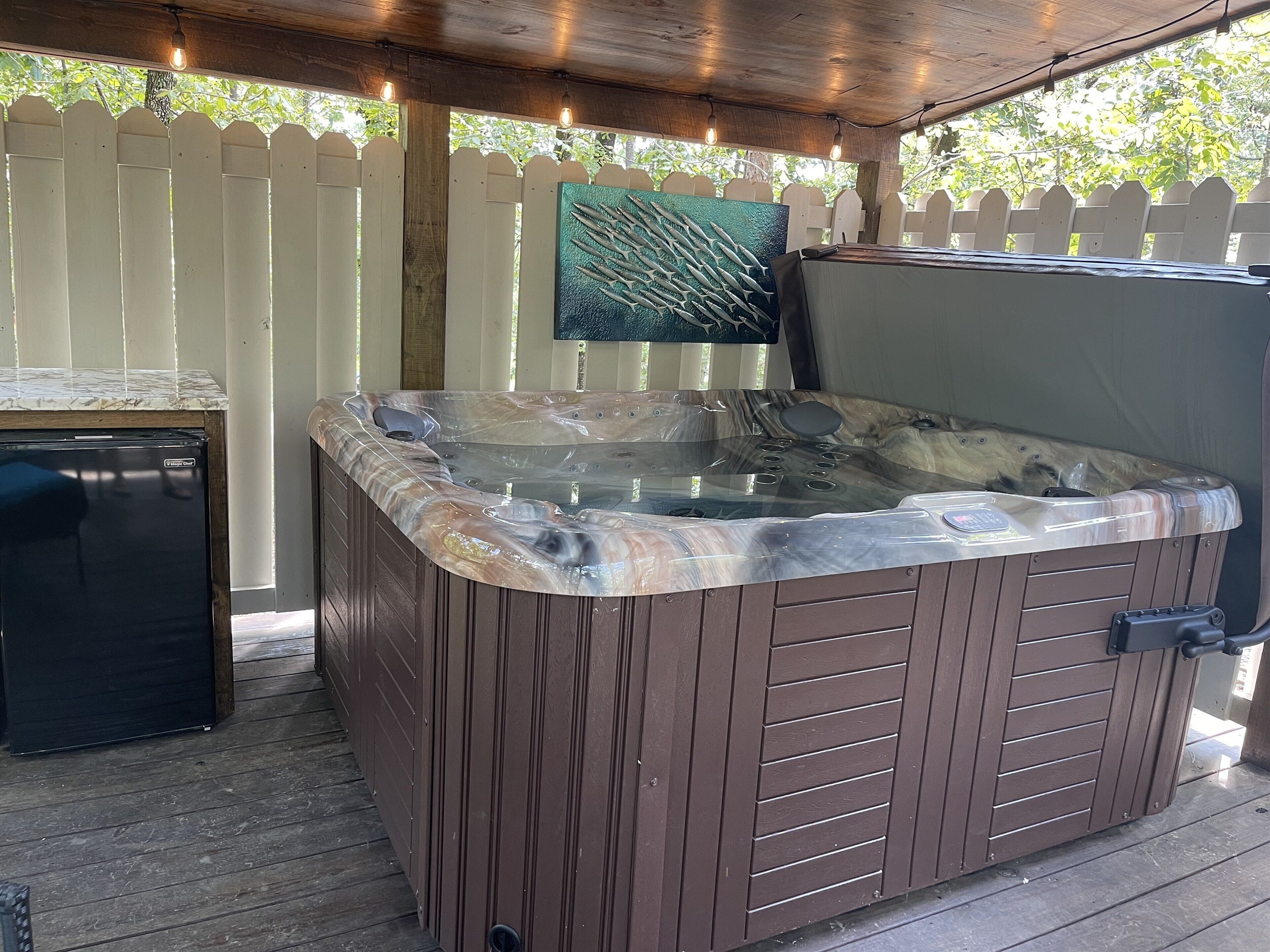 Enjoy a cool beverage in the hot tub by taking advantage of the outdoor refrigerator in arms reach.