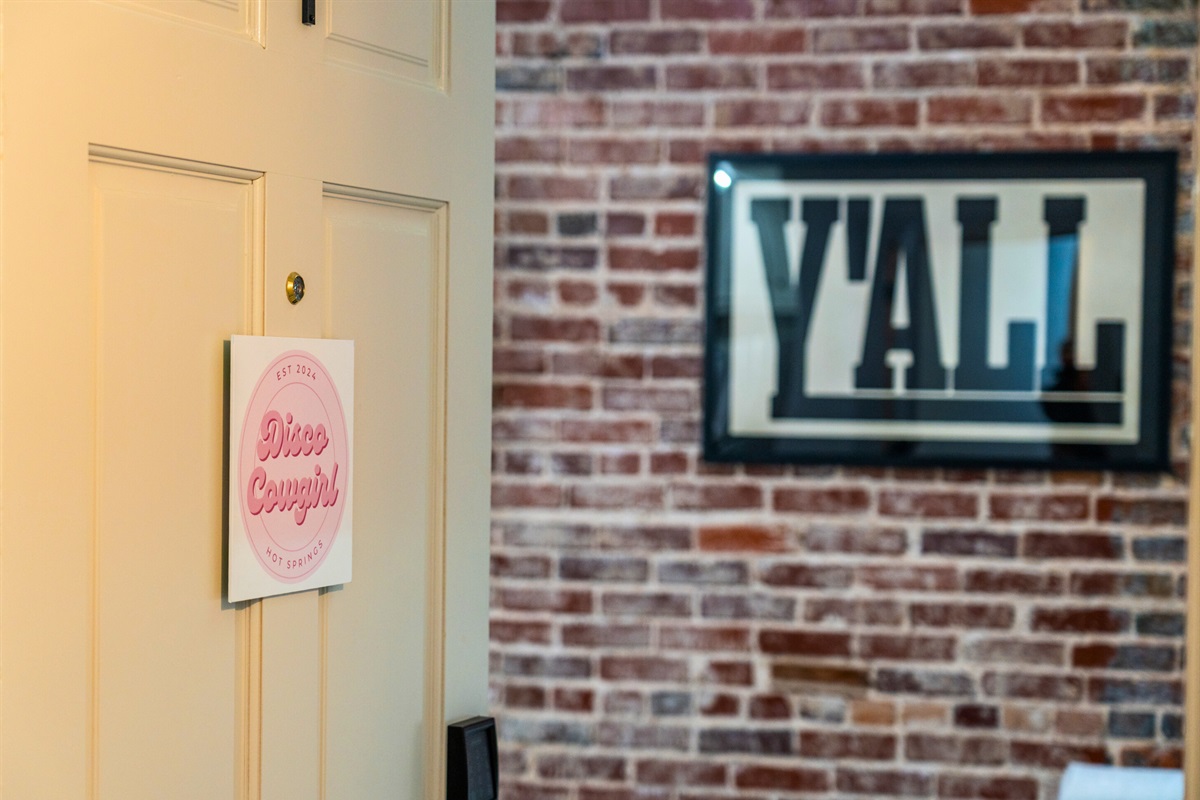 A fun “Y’all” sign adds a welcoming Southern touch to the decor, capturing the essence of this unique downtown loft.