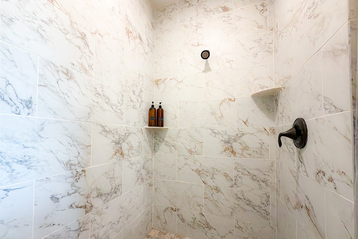 full tile and marble master suite bathroom.