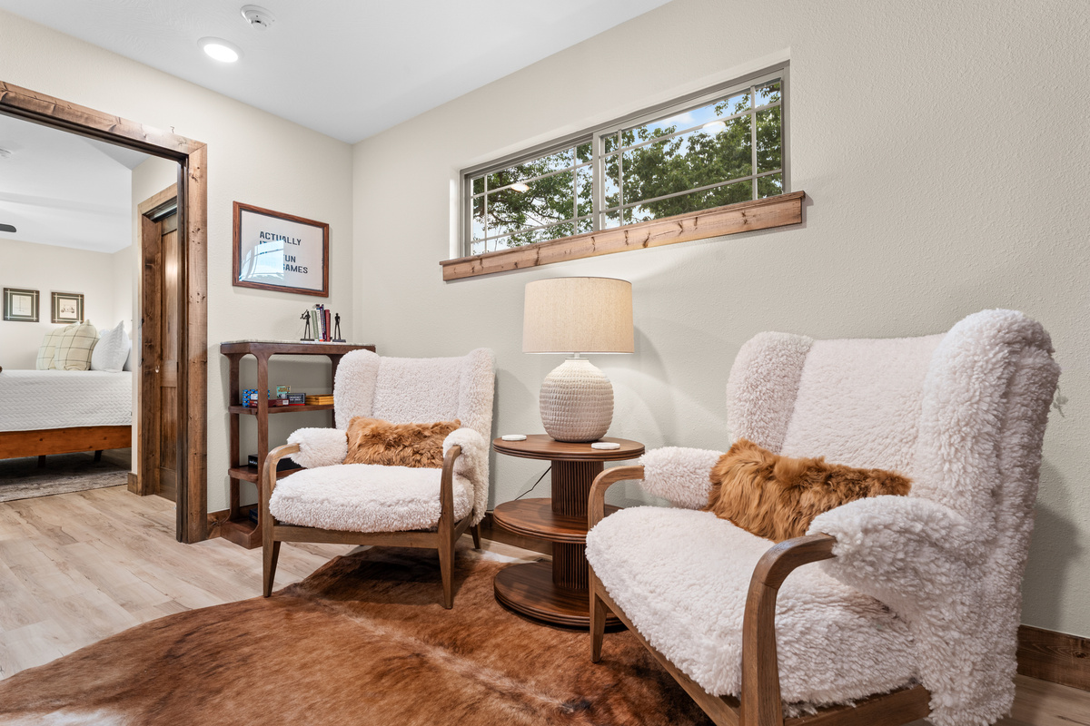 Head upstairs to the private primary bedroom. Curl into a sherpa chair in the loft nook — the family game shelf is an arm's reach away.