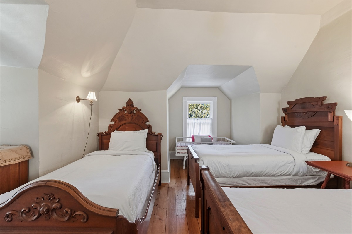 Beautiful antique furniture with comfortable bed linens. 