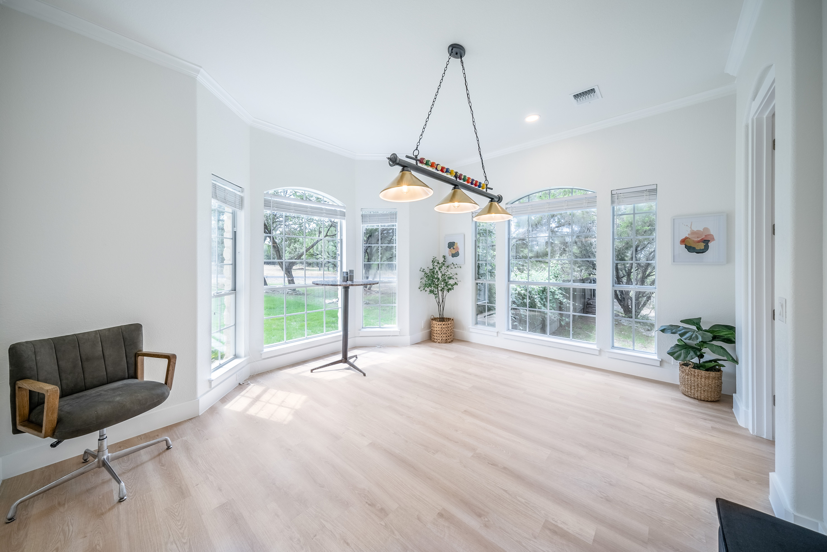 Spacious flex room with a designer chandelier — ideal for gatherings and events.