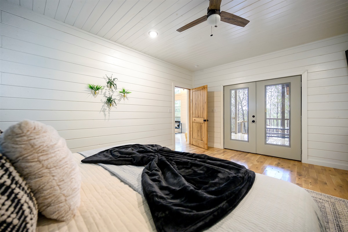 A relaxing private suite with a king bed and simple, comfortable design for a restful stay.