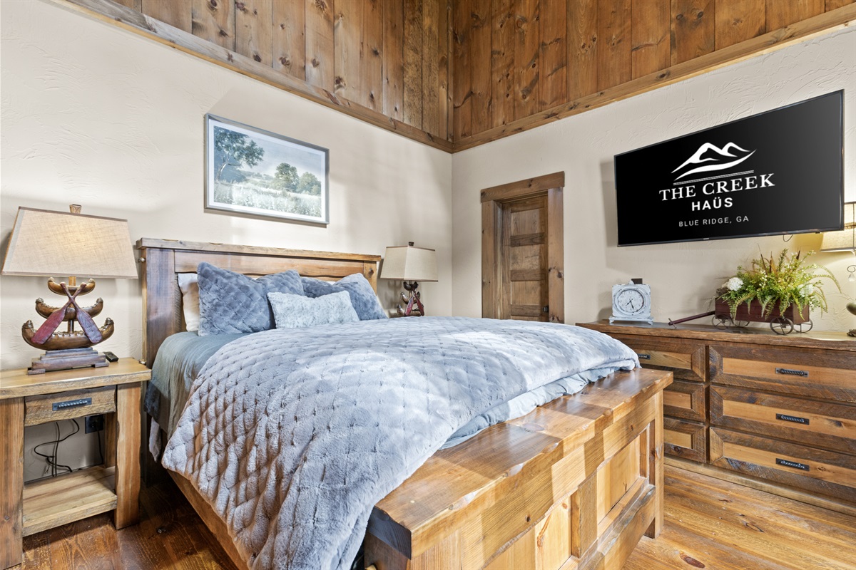 This queen bedroom is a charming retreat, complete with soft linens, thoughtful touches, and a relaxing ambiance.