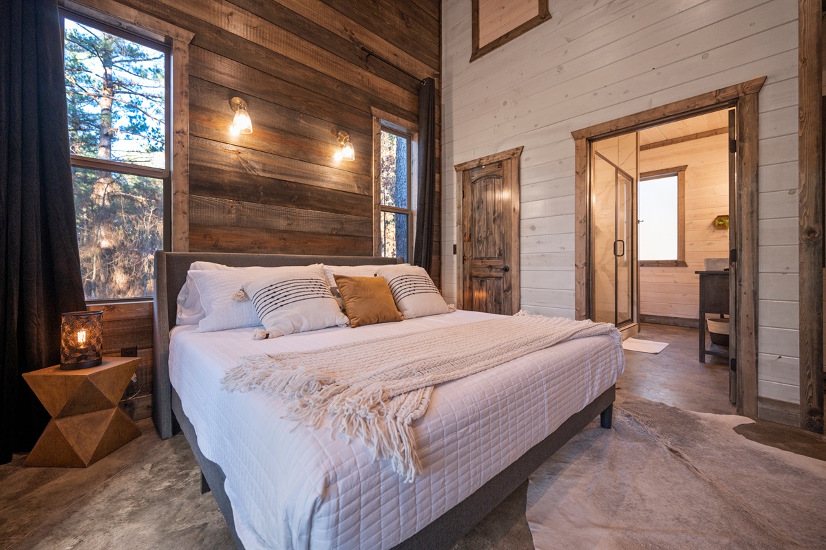 Soft linens and warm cabin touches create a peaceful private retreat.