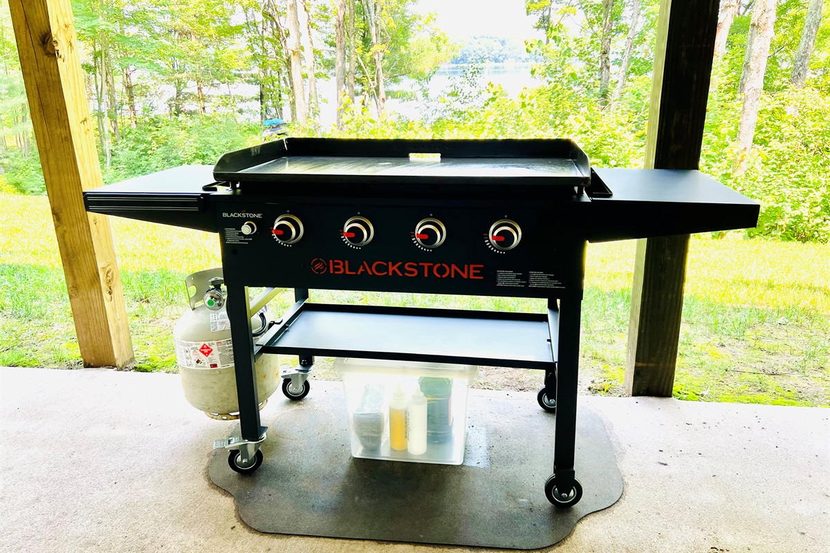The Blackstone gas griddle is located on the lower level concrete patio facing the lake.