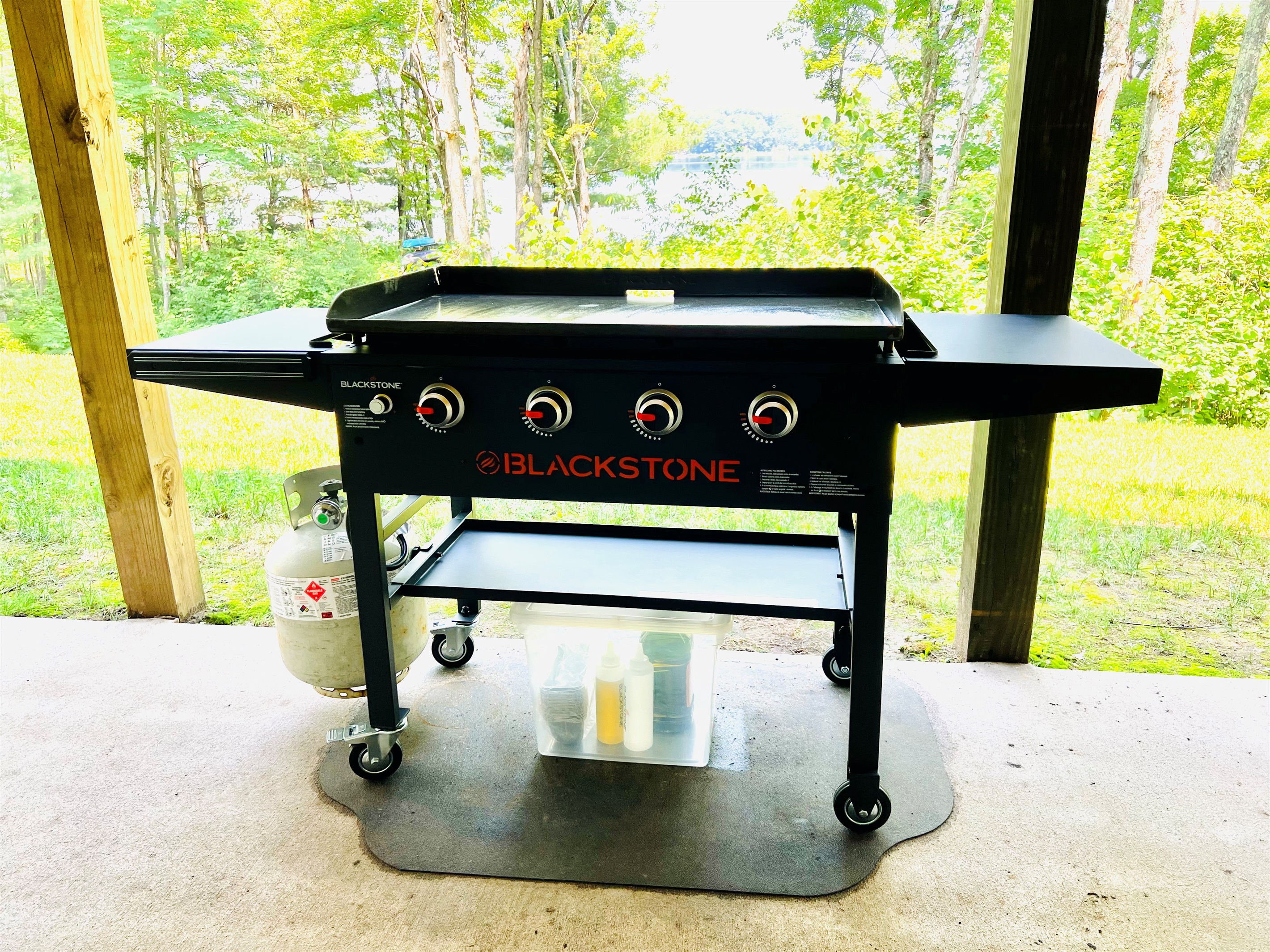The Blackstone gas griddle is located on the lower level concrete patio facing the lake.