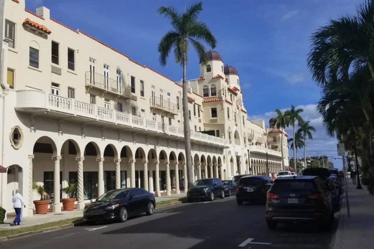Beautiful architecture with shops along the front of the building. 