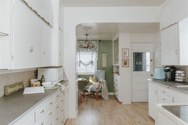 Imagine Grandma's pie cooling in this well stocked kitchen. An entertainer's dream assortment of vintage china, tablecloths, napkins and glassware. 