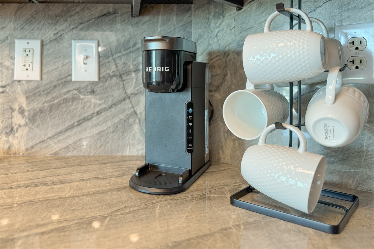Start your day right with this well-equipped kitchen countertop. Featuring a Keurig coffee maker - your morning routine just got easier.