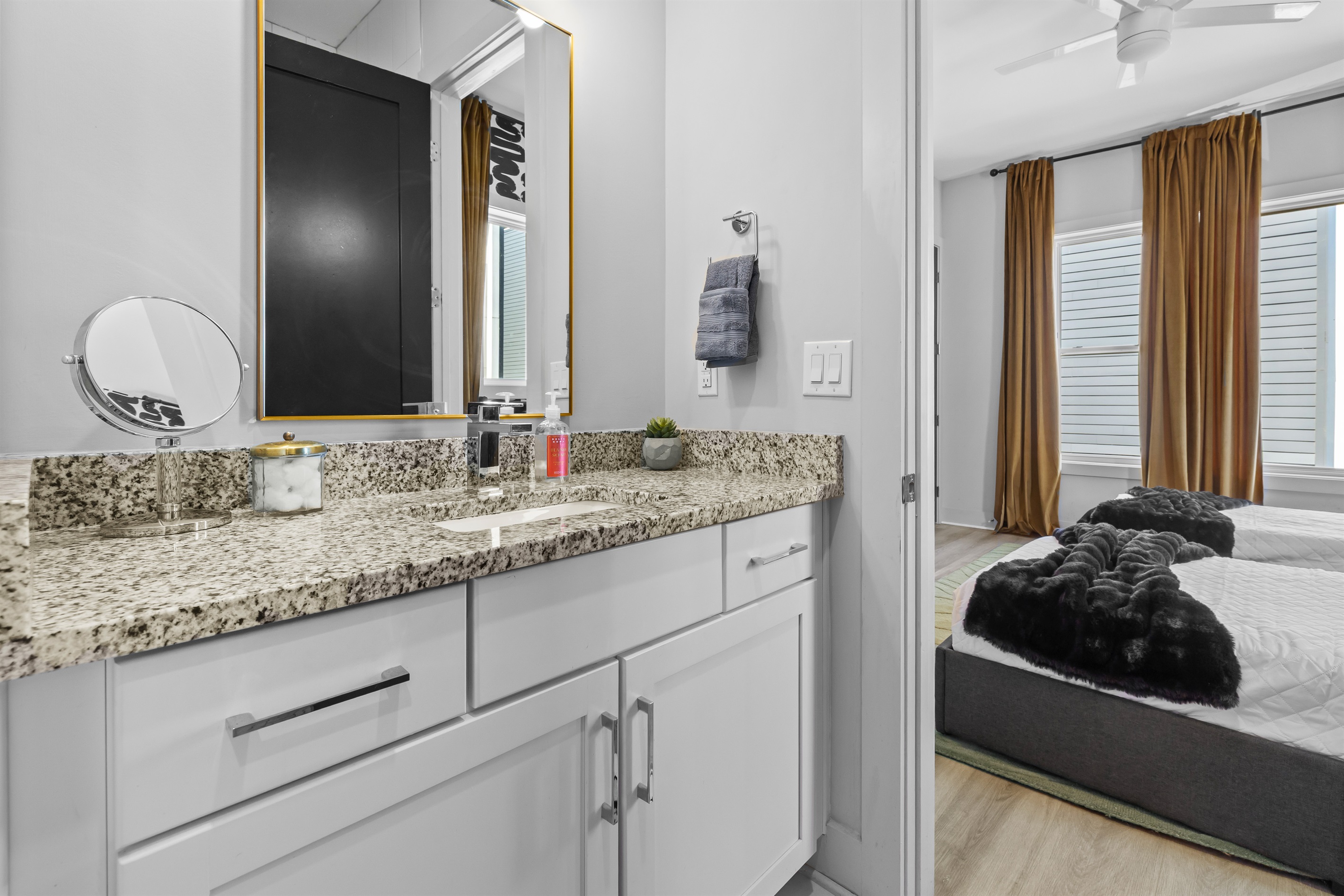 Bathroom Retreat: Elegant granite vanity and natural light create a refreshing oasis for guests!