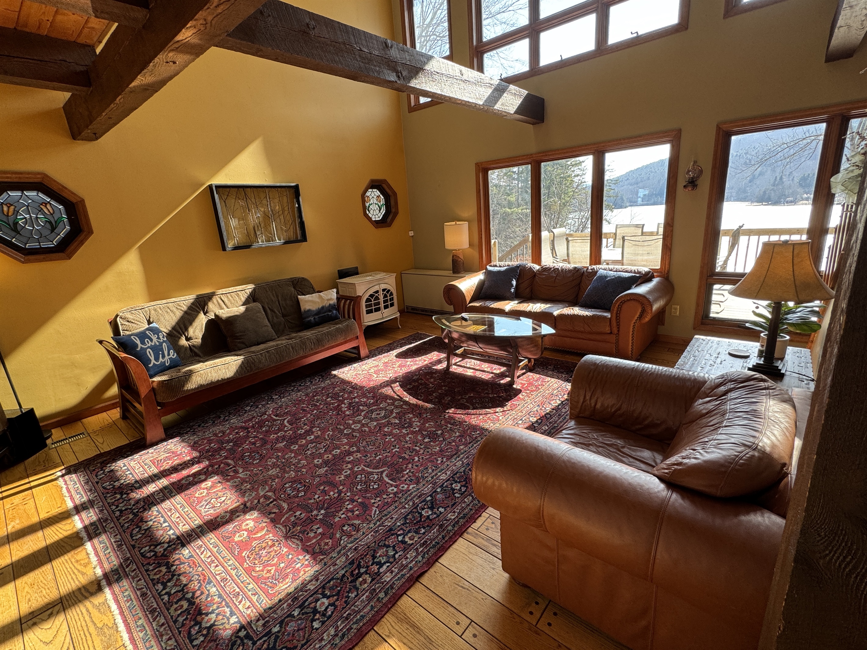 Camp Havon living room filled with light - looking onto the deck and Goodyear Lake.