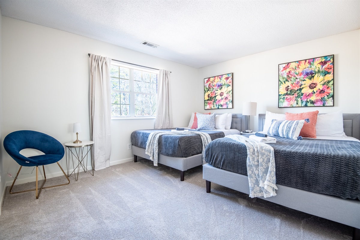Our spacious double queen bedroom is perfect for late-night chats, putting on makeup at the full-length mirror, or cozying up in the corner with your favorite book.