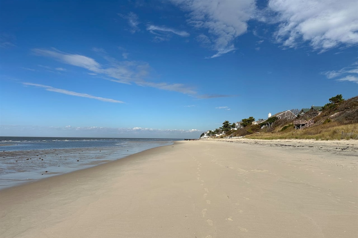 Experience the serene beauty of the expansive sandy beach, just steps from your front door. This tranquil shoreline offers wide-open spaces and clear blue skies, perfect for a peaceful stroll or a day of sun-soaked relaxation.