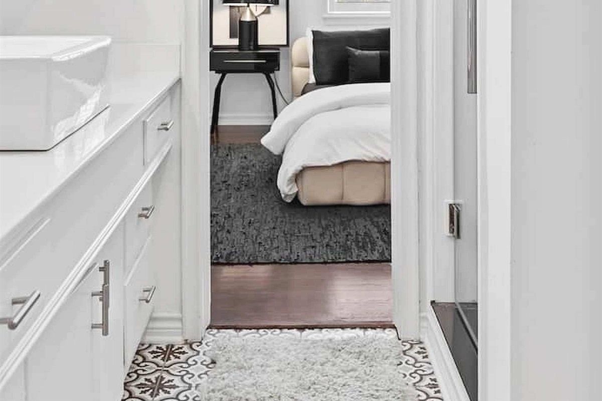 Clean and comfortable bedroom suite with bright natural light, soft finishes, and convenient access to the adjoining bathroom.