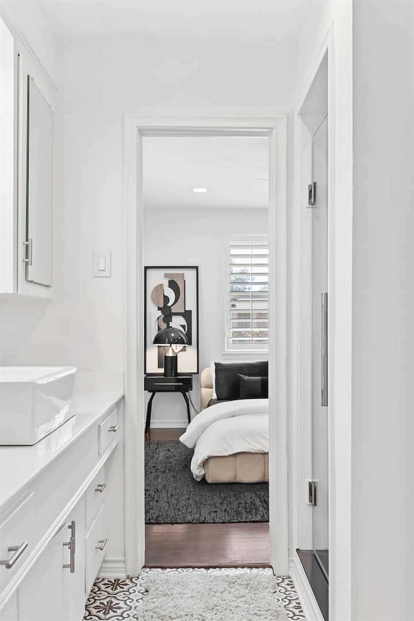 Clean and comfortable bedroom suite with bright natural light, soft finishes, and convenient access to the adjoining bathroom.