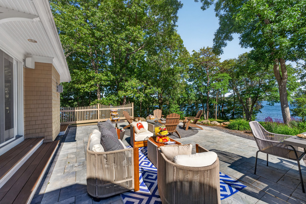 A full layout of lakeside living—grill, firepit, seating, and the water just steps away.