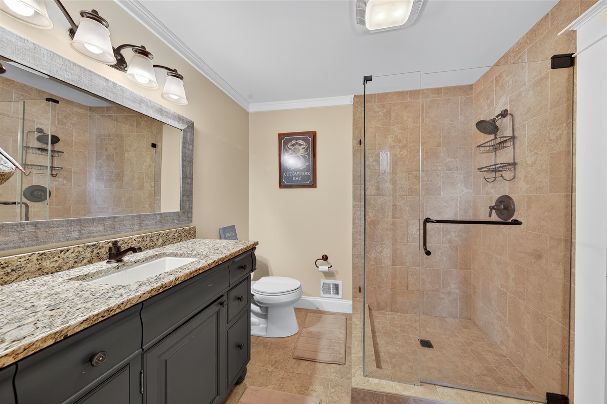 Walk-in tiled shower with upgraded fixtures for a spa-like experience.