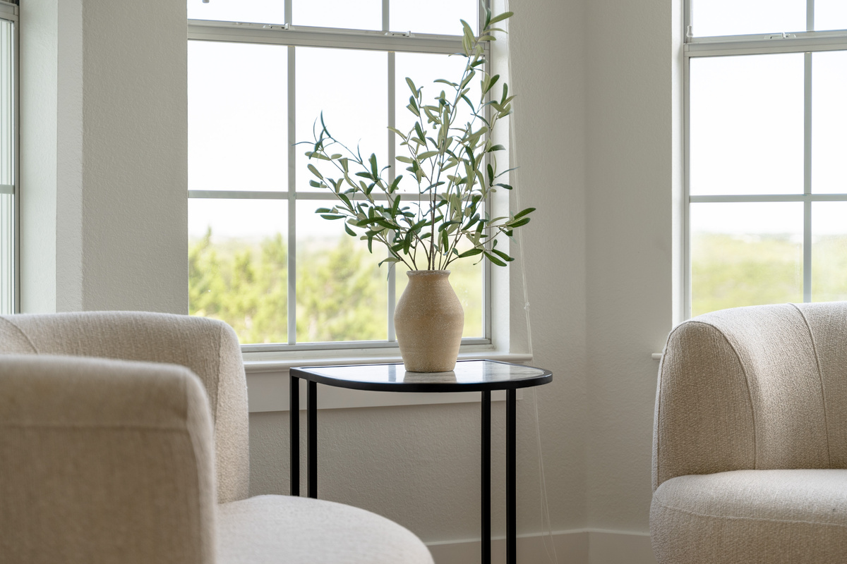 Elegant sitting area with cream armchairs, ideal for morning coffee.