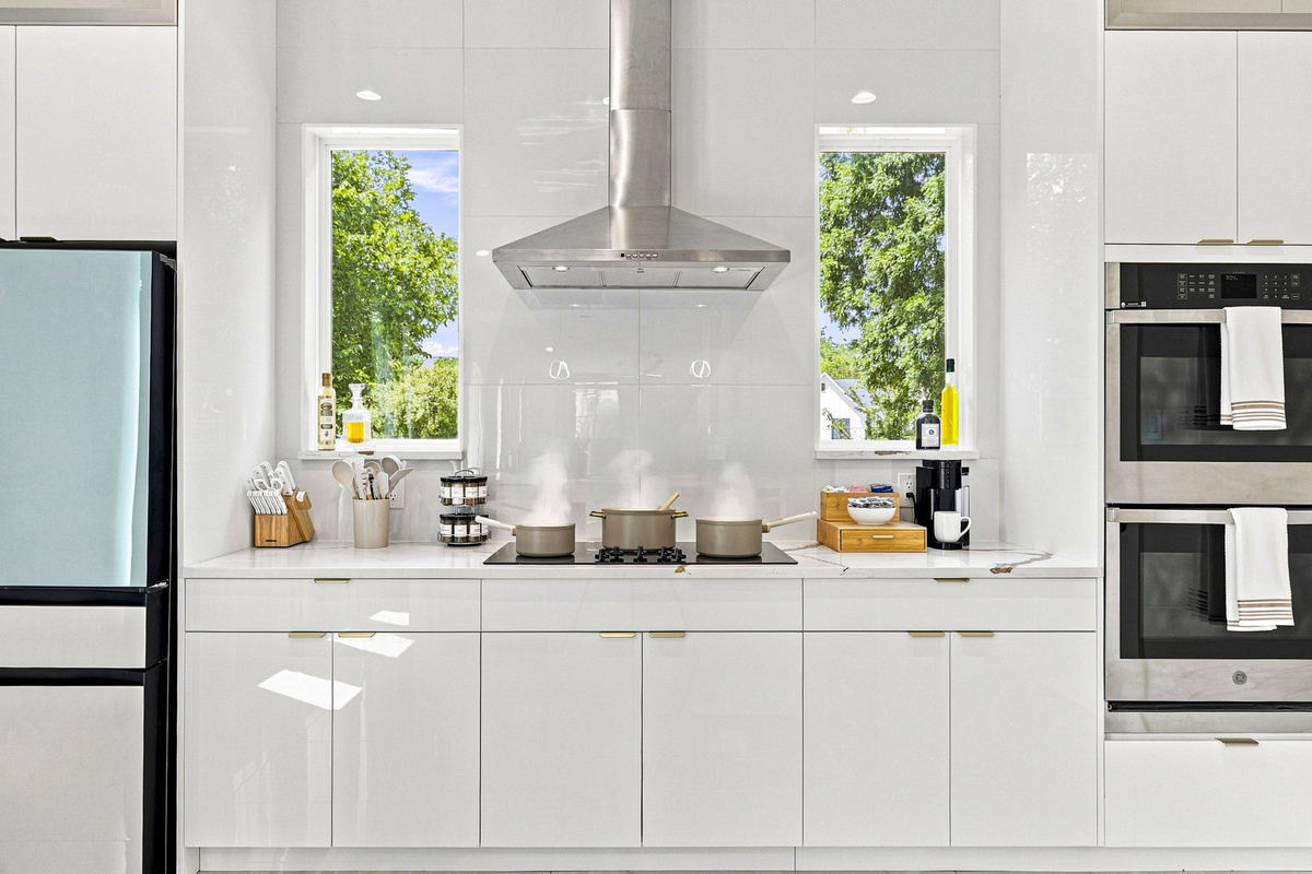 Modern design meets culinary creativity with bright windows and stylish appliances!