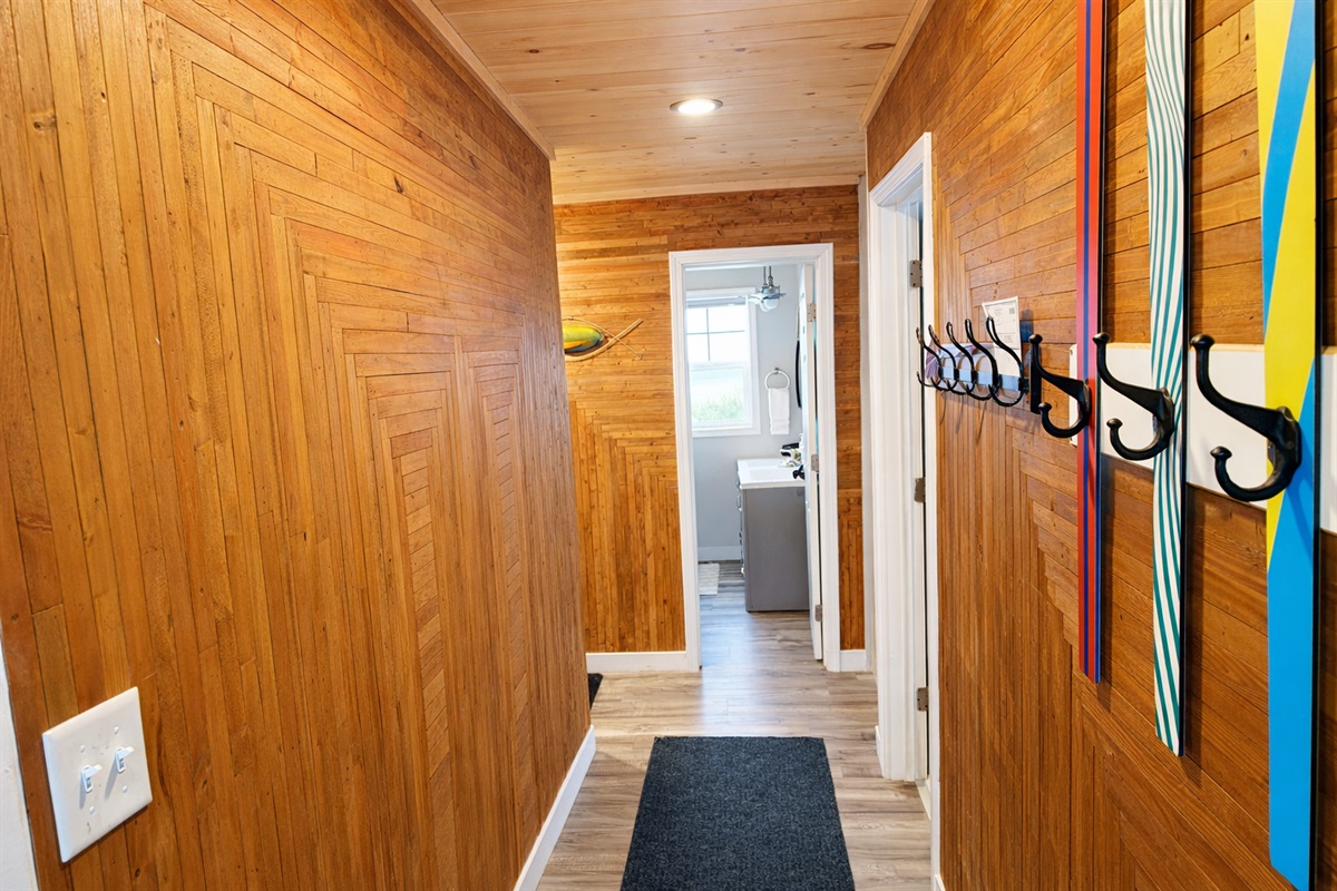 Step into the entryway and you’ll catch a unique blend of charm and function. A row of quirky hooks some crafted from skis welcomes you to hang up your gear. Straight ahead, you’ll get a glimpse of the bathroom window offering a peek at Lake Superior. 