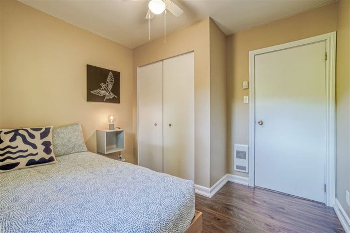 Double bed in bedroom three with overhead fan and lights