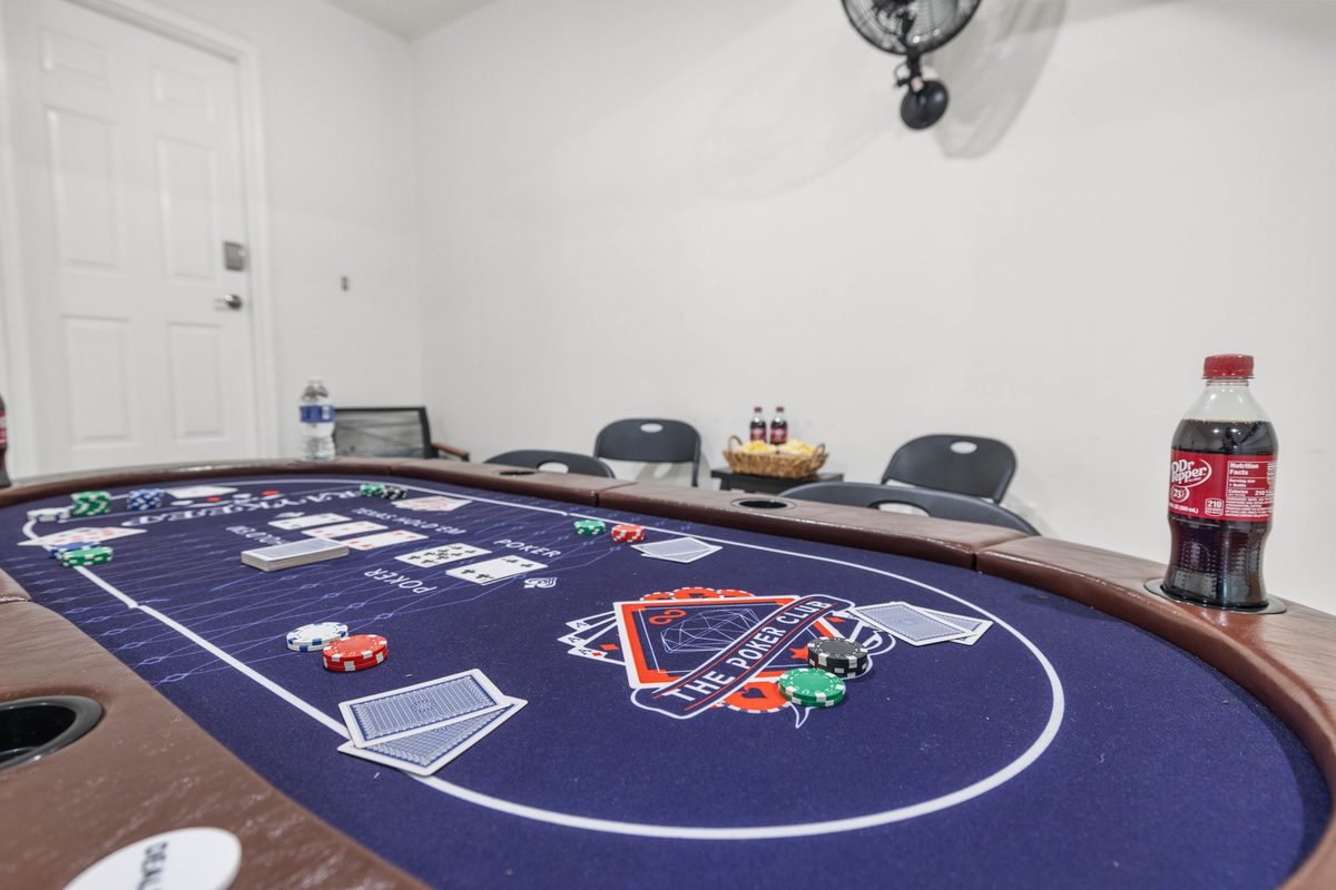 Game room in garage includes ping pong table, poker table and foosball table