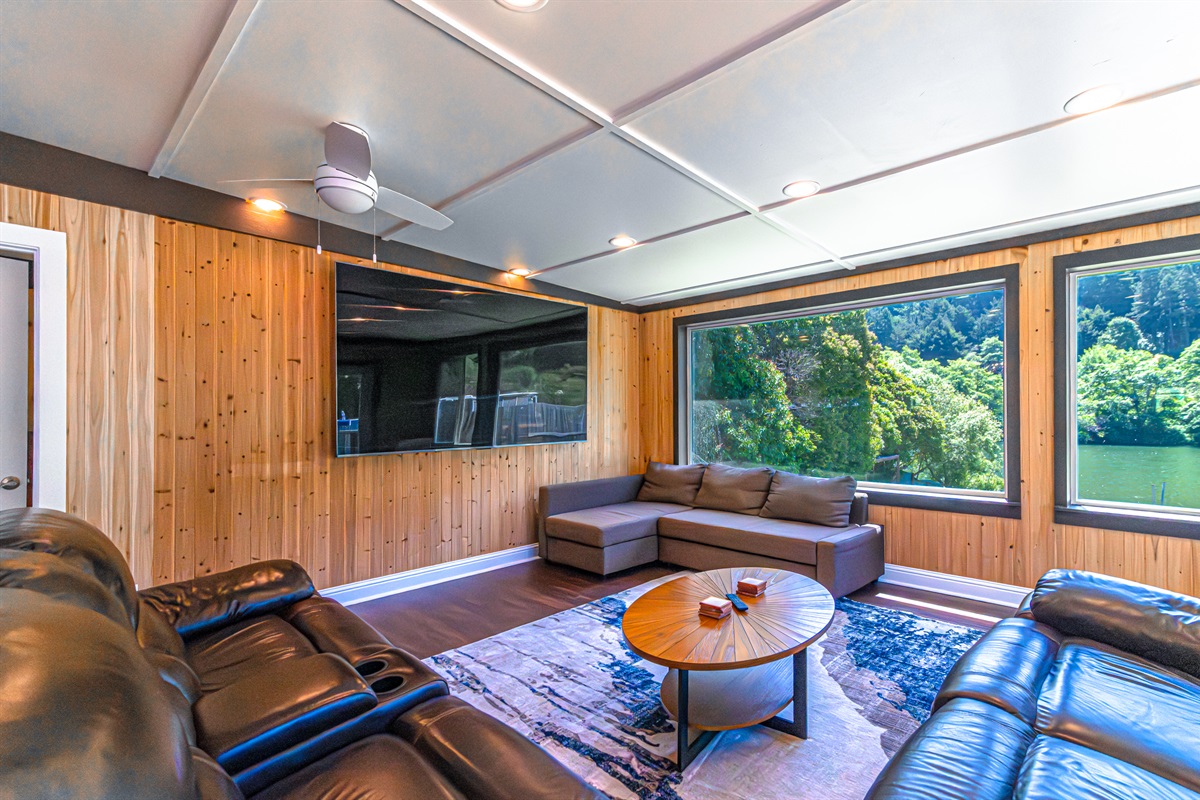 The heart of the home invites relaxation with refined comfort and spectacular river vistas. Sink into plush seating and unwind before the impressive large-screen Smart TV, creating the perfect setting for movie nights, sporting events, or simply gathering