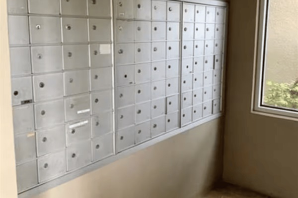 The mailroom is downstairs towards the end of the long hallway entrance.