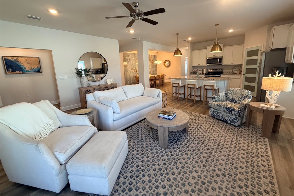 Bright, open-concept space connecting living, dining, and kitchen for seamless group gatherings.