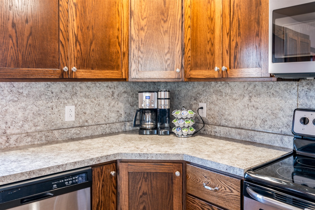 Whip up your favorite meals in this modern kitchen with stainless appliances, coffee maker, and all essentials.