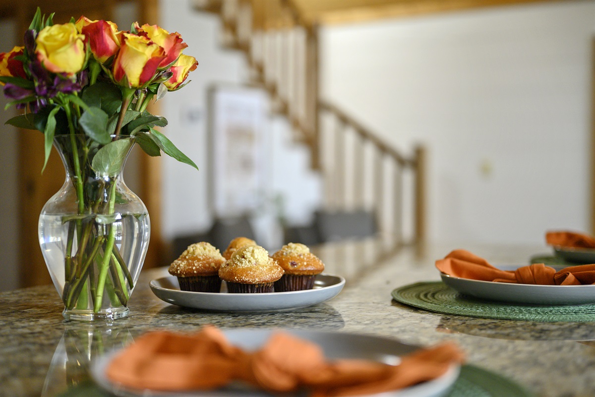 Indulge in a sweet start to your day with freshly baked muffins and a touch of floral charm