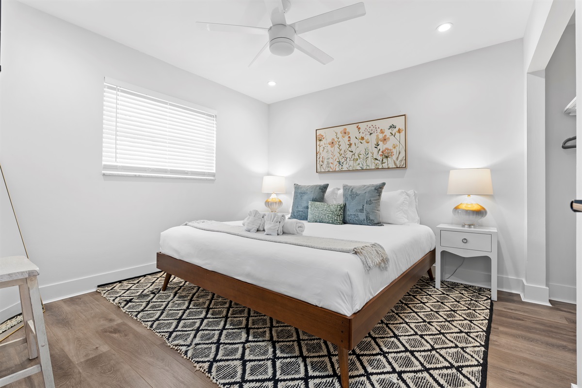 Drift into comfort in this serene king bedroom, styled with plush linens, soft lighting, and calming coastal touches.