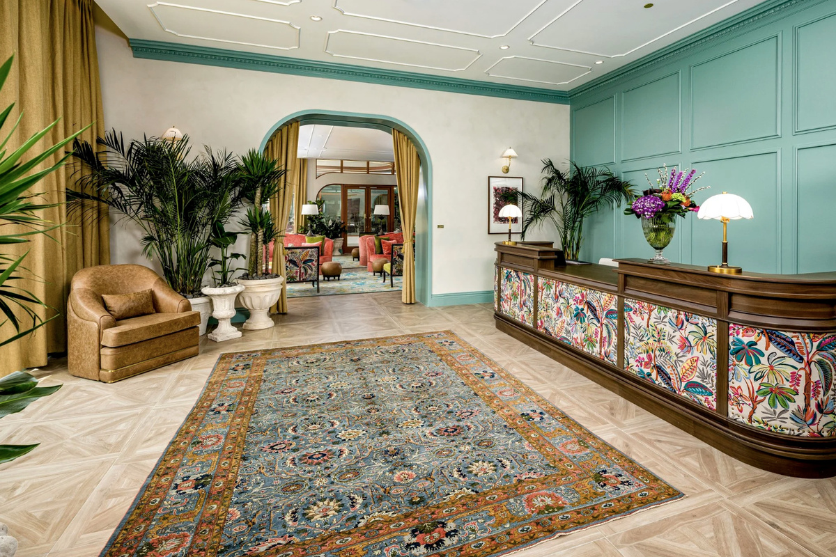 The grand lobby lounge welcomes you with layered rugs, lush plants and concierge service.