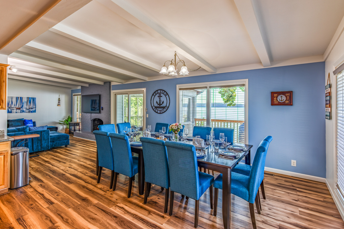 The open dining area connects naturally to the kitchen, living room, and lake-facing screened porch.