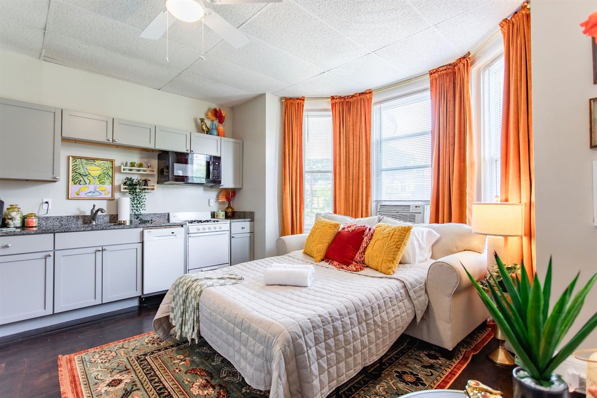 Spacious living area featuring a full sofa bed, offering both a comfortable seating area during the day and an extra sleeping option for guests at night.