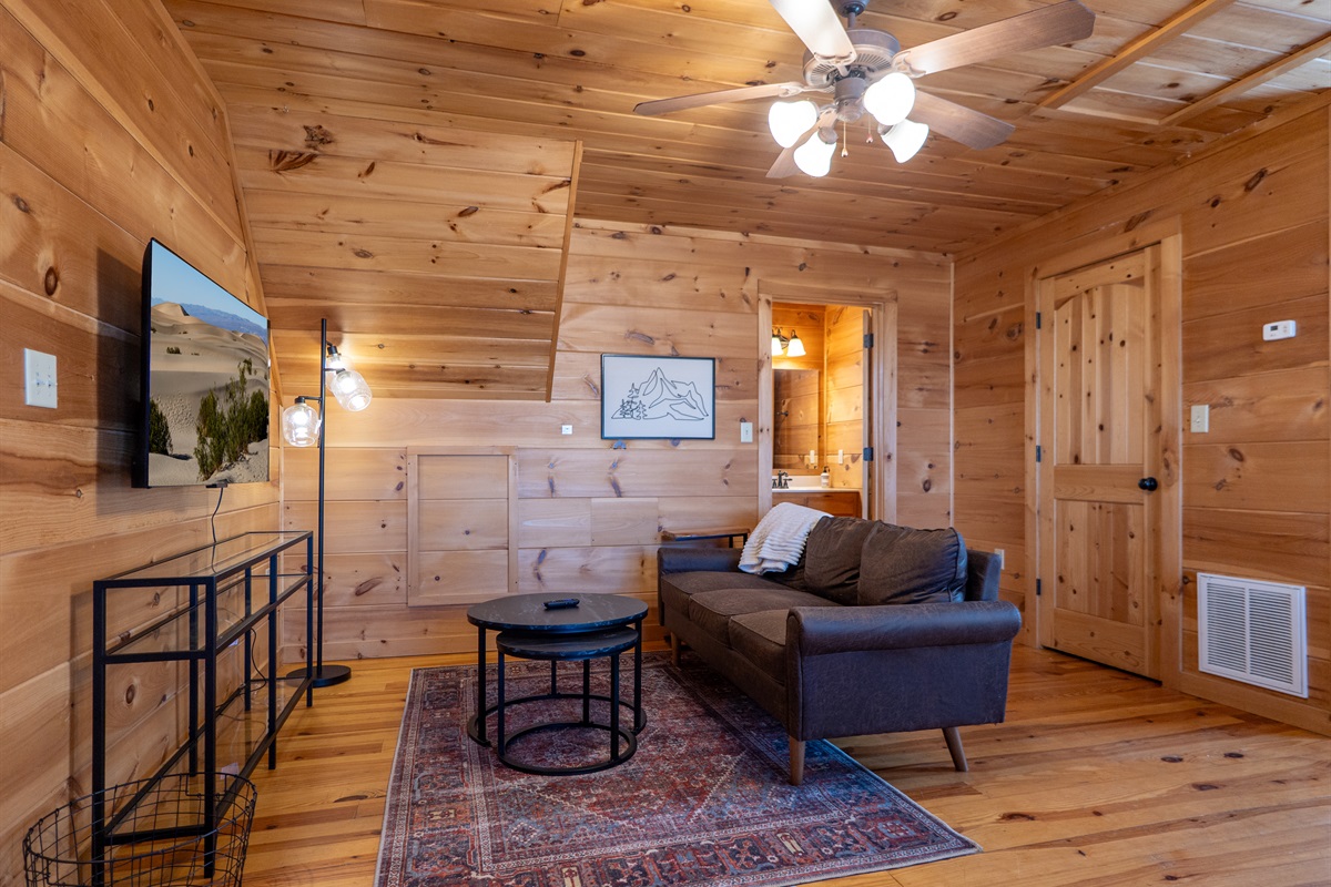 The primary suite offers a perfect blend of comfort and style, with a comfortable seating area for relaxation.