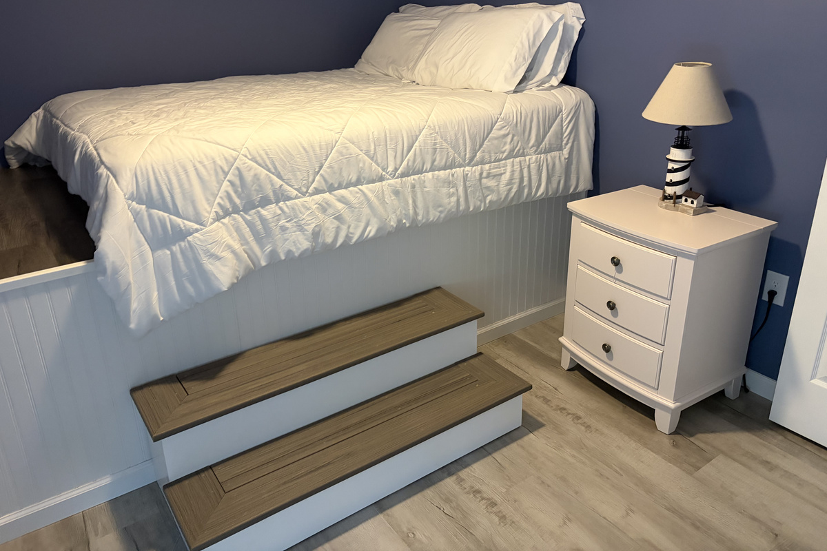 Twin bedroom with nightstand and storage bench