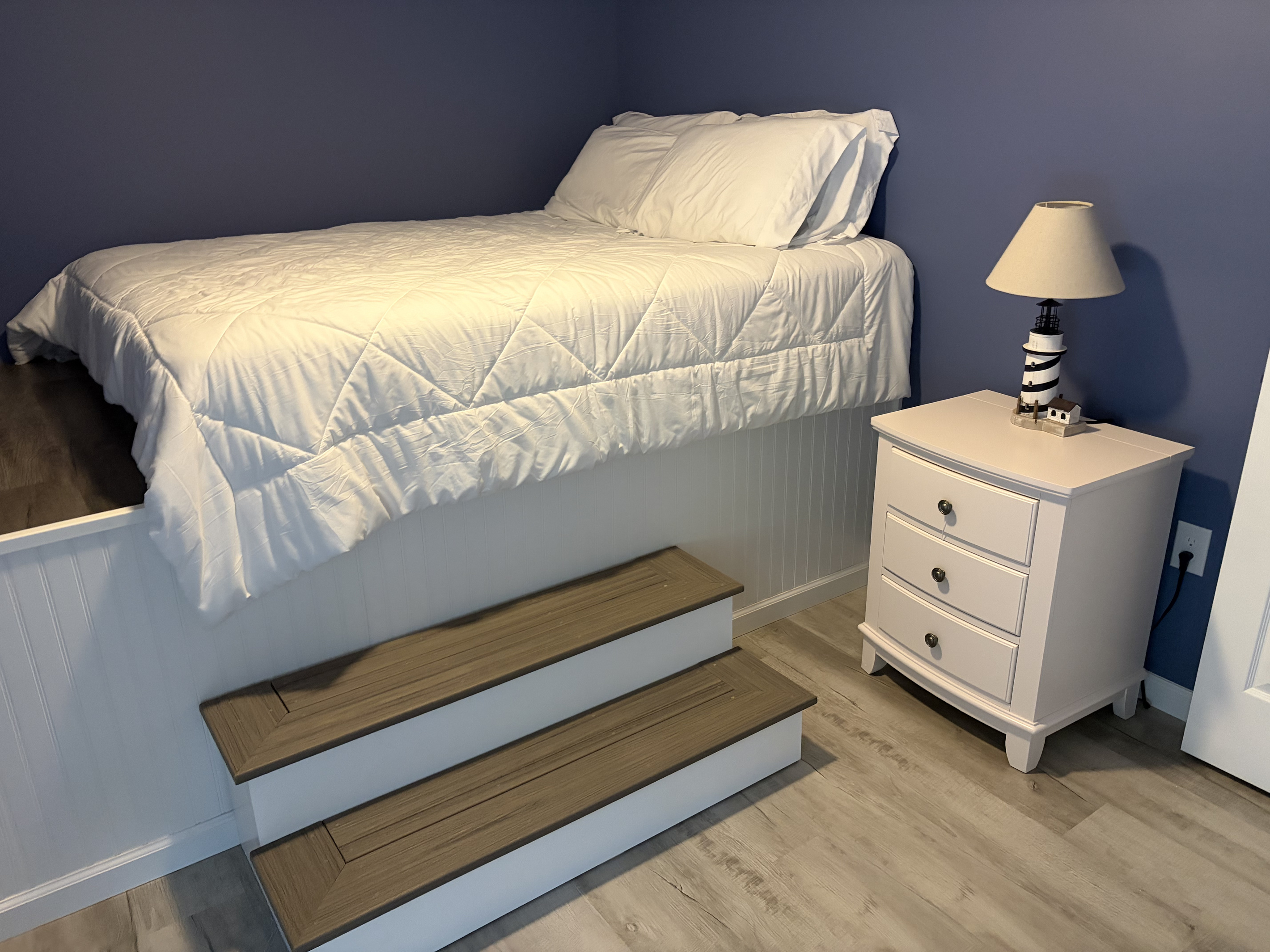 Twin bedroom with nightstand and storage bench