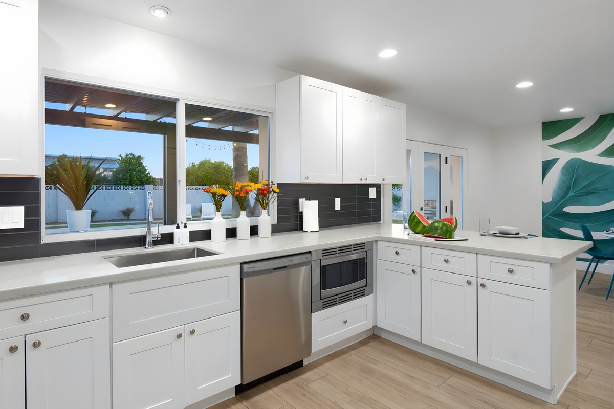 Stainless steel appliances and a view of the pool make the kitchen a pleasure