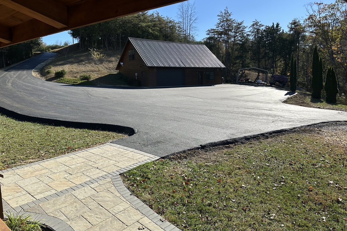 Very large paved parking lot and nice walkways from parking lot front of cabin and around the side of the cabin to the back patios.