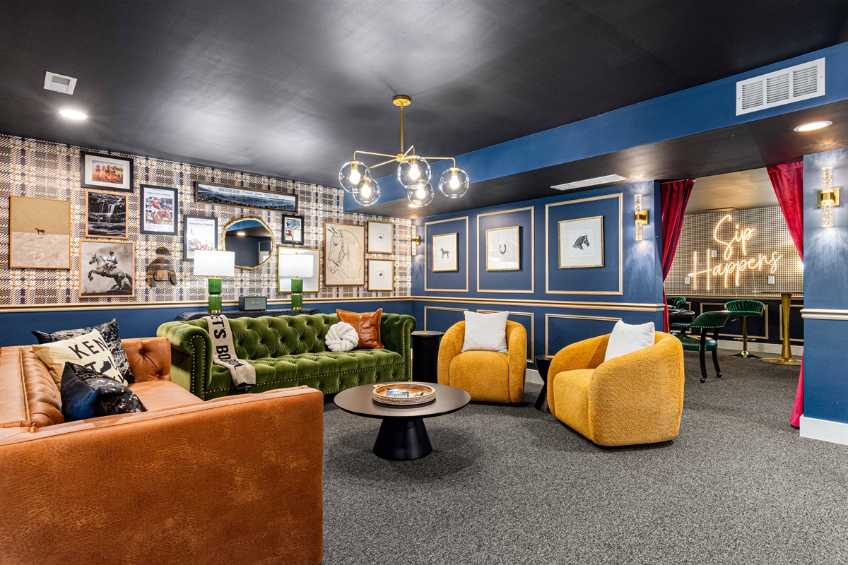 Lounge leading into the poker room/opposite side is the sliding doors leading to the hot tub, firepit, and pool area