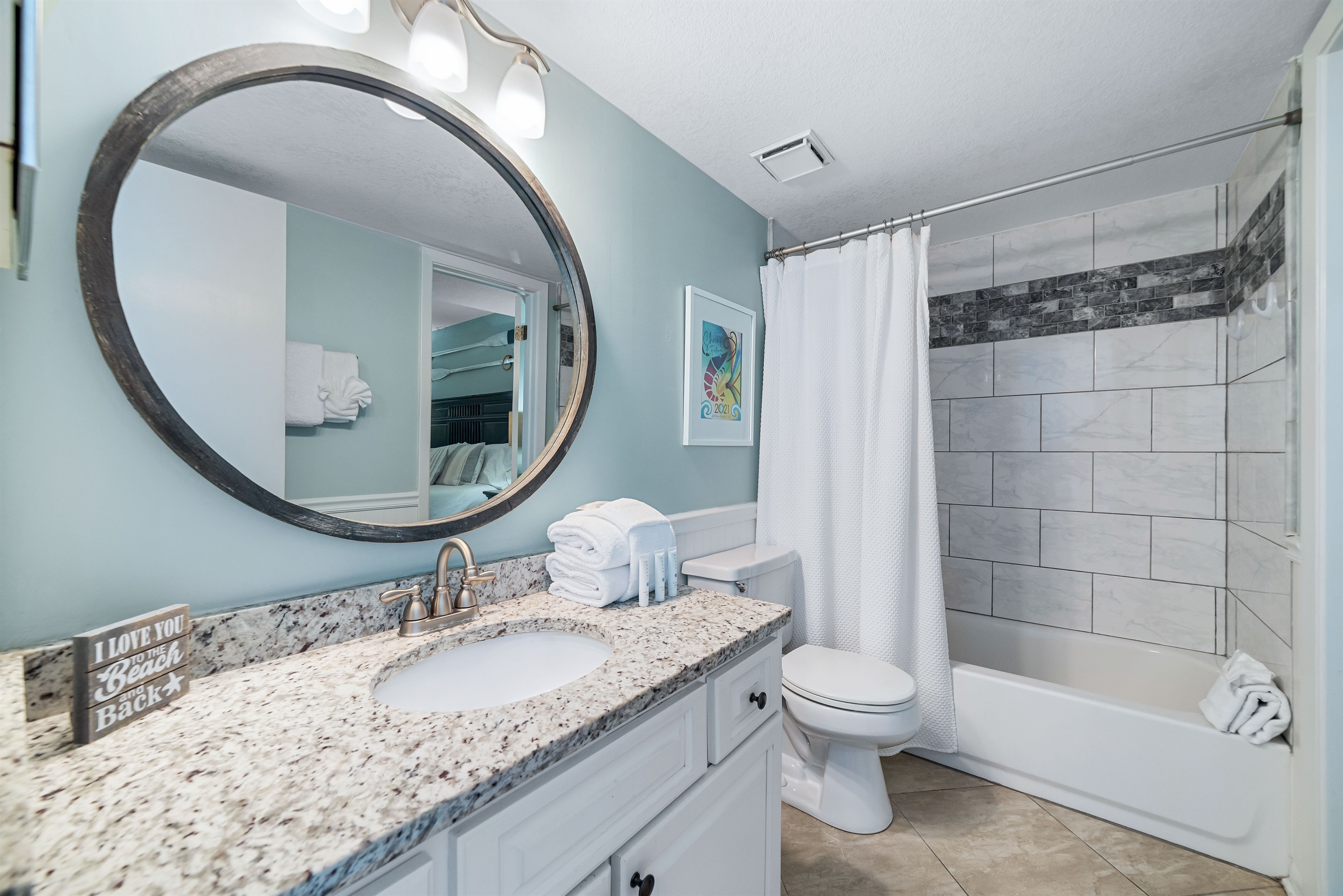 Freshly updated bathroom featuring a shower/tub combination, ample vanity space, and modern fixtures.
