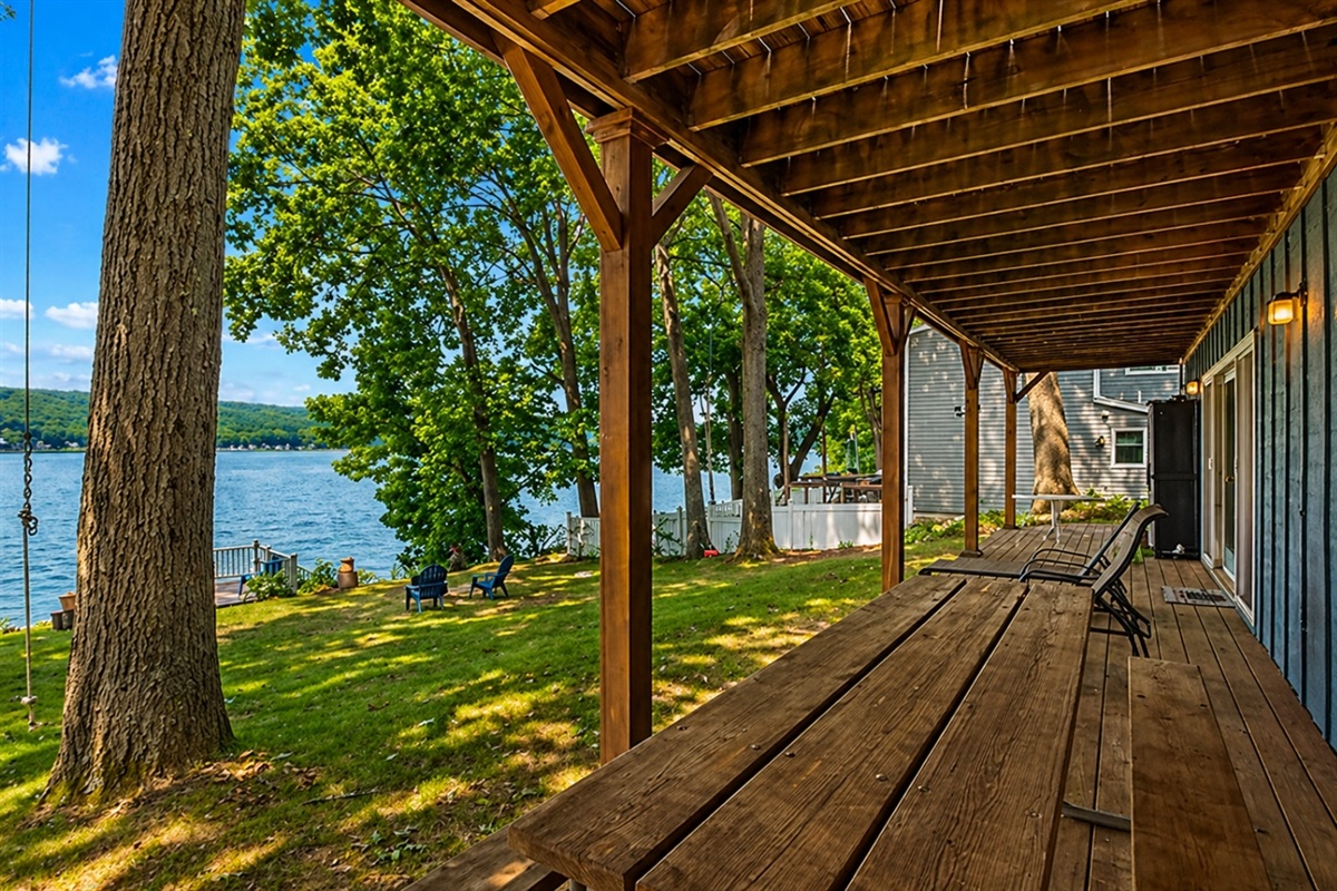 Dine al fresco or relax in the shade on this spacious covered patio, just steps away from Honeoye Lake. ️