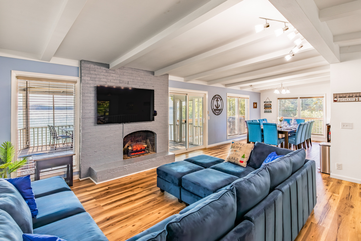 Relax on the oversized sectional beside the fireplace and large Roku TV in the main living room.