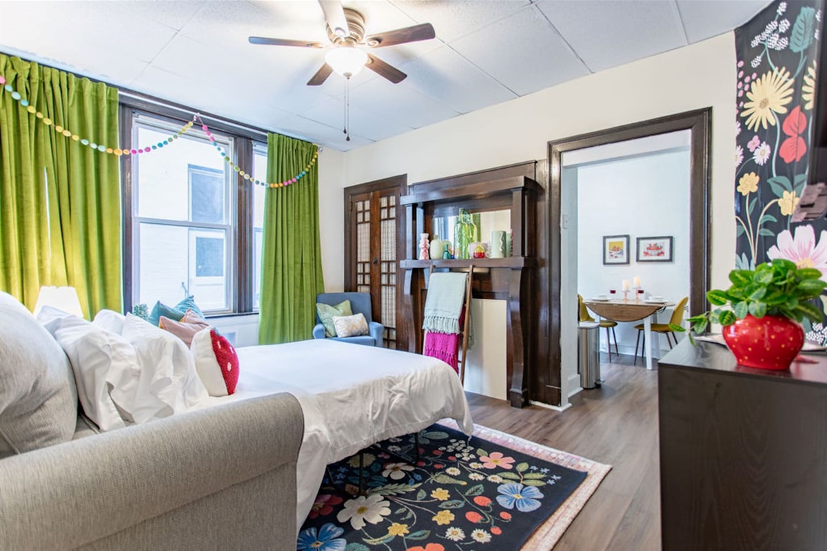 Bright and spacious living room featuring a comfortable sofa bed, perfect for relaxing or accommodating extra guests.