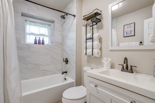 Freshly renovated bathroom with stylish tile and stocked with all essentials