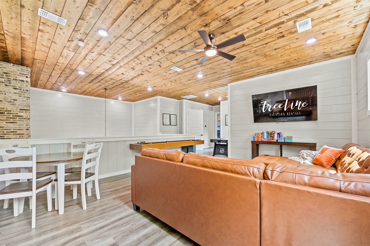 Luxury meets leisure in our game room—complete with a plush leather sofa and space to play and unwind.