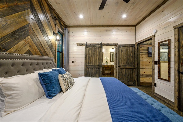 Inviting rustic bedroom with modern comforts and beautiful walk-in shower.